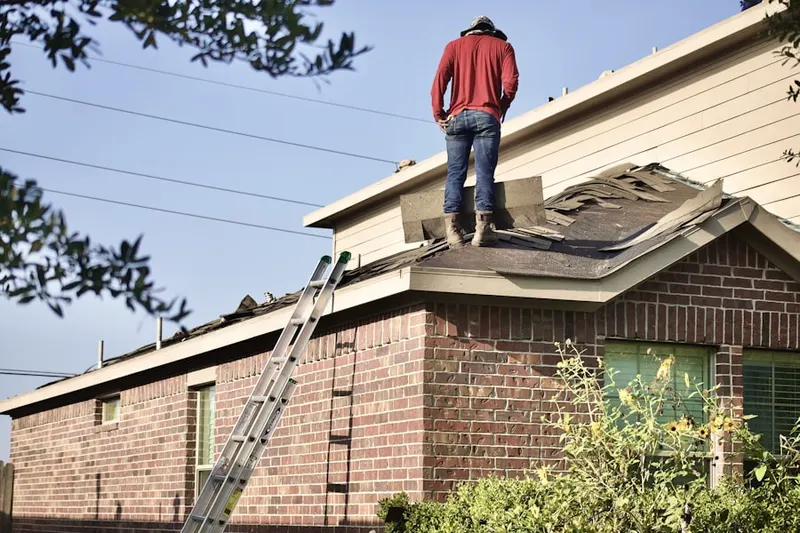 Professional roofer working on a residential roof in Little Run Estates